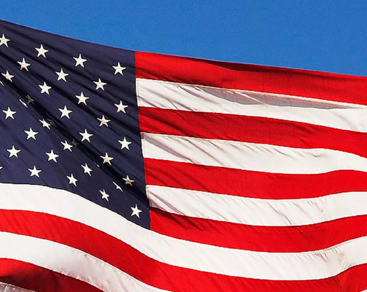 An American flag flying on a flagpole.